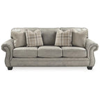 Divano con braccioli arrotolati e finiture a borchie | Rivestimento in finta pelle scamosciata grigio acciaio | 231 cm L x 96,5 cm P